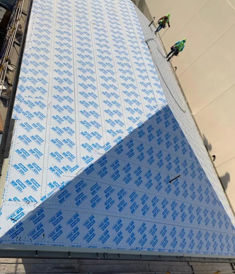 Professional roofers installing underlayment on a metal roof in New Cumberland